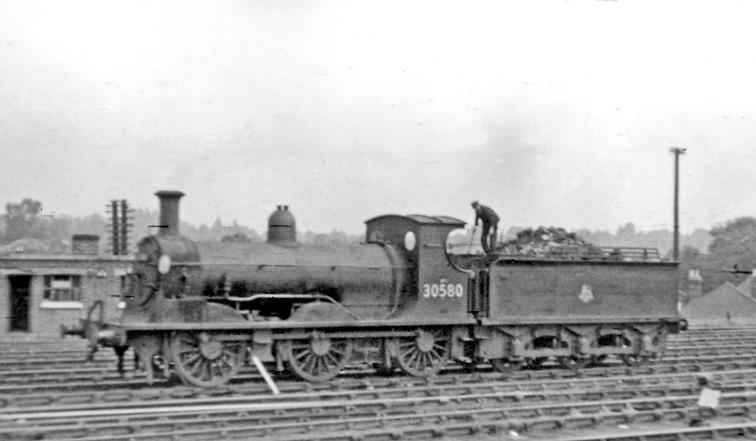 www.BloodandCustard.com
Shunting in the extensive yards west of Woking station, ex-LSWR Adams no.30580 was built as no.506 in December 1885, becoming no.0506 then SR no.3506 and finally BR no.30580, to be withdrawn in April 1957.
 Ben Brooksbank (CC-by-SA/2.0)
