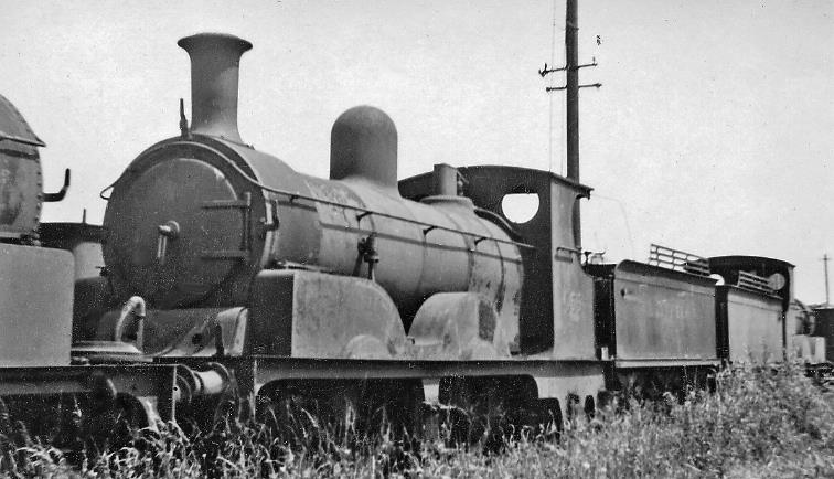 Ex-LSWR Adams 0-4-2 dumped at Eastleigh Locomotive Depot along with some twenty other condemned locomotives, Adams A12 class no.555 (built December1889, withdrawn March 1943) has been dumped at the far end of the Locomotive Yard for months/years, rusting away surrounded by weeds. 
 Ben Brooksbank (CC-by-SA/2.0)
