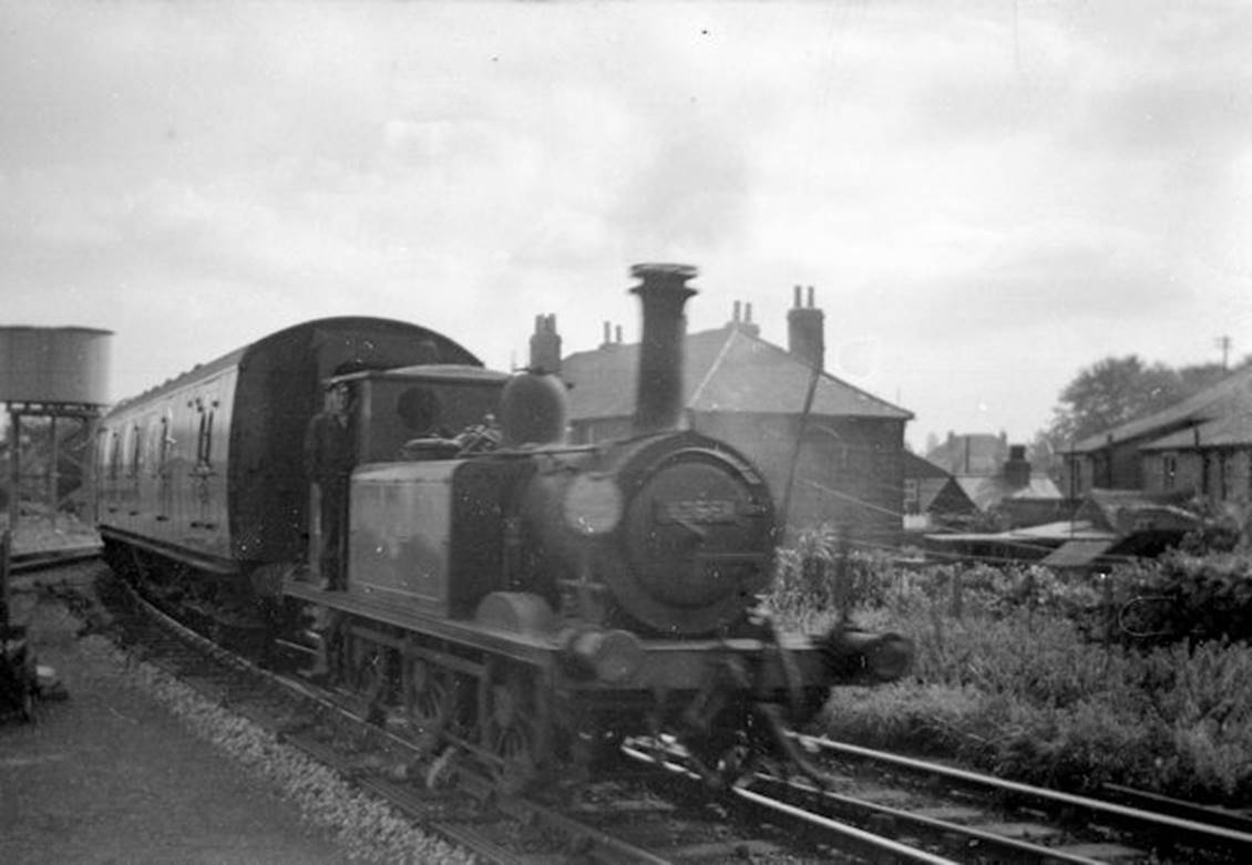 1961
No.32661 has just crossed New Lane and is entering Havant Station. The first coach is a Bulleid Multidoor Brake Second, 3 COR set 978 being used on the branch between 1959 and 1962 albeit as a 2 COR (plus loose BSK).
In 1963 driving brake second of pull-push set no.619 was also seen operating with two Mk1 seconds operating on the branch albeit not in pull-push mode.
  John Firth (CC-by-SA/2.0)
