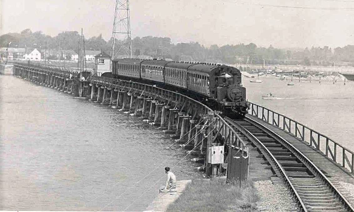 Crossing Langstone Bridge with a Havant train is an unidentified  Terrier  hauling a four-coach train. The second and fourth Mk1 non-corridor coaches are sandwiching a Bulleid semi-open BSK, whilst the first coach is unclear.
  Glen Woods collection (Bluebell Railway Museum)
