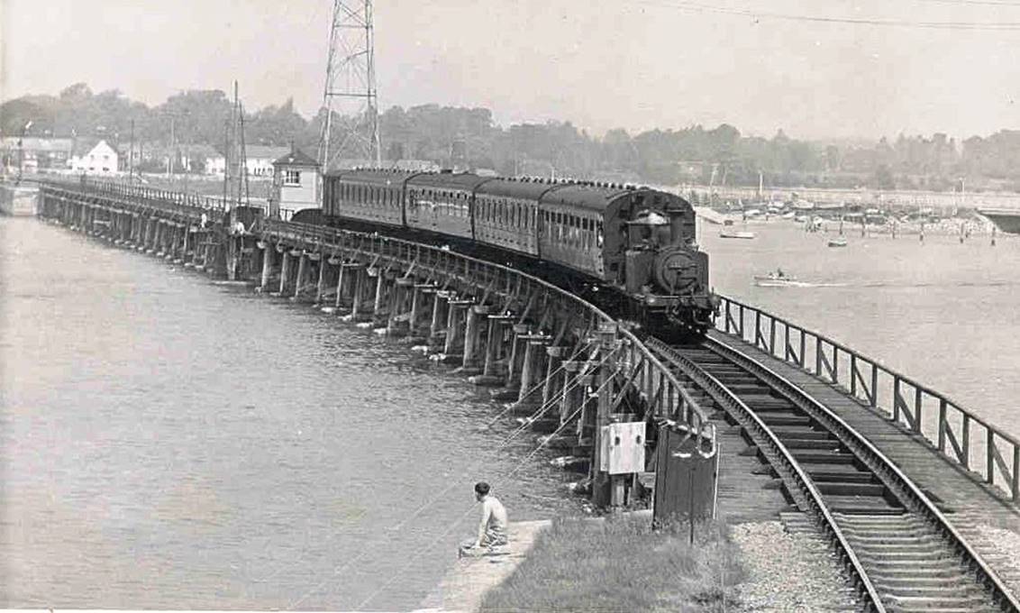 Crossing Langstone Bridge with a Havant train is an unidentified Terrier hauling a four-coach train. The second and fourth Mk1 non-corridor coaches are sandwiching a Bulleid semi-open BSK, whilst the first coach is unclear.
 Glen Woods collection (Bluebell Railway Museum)
