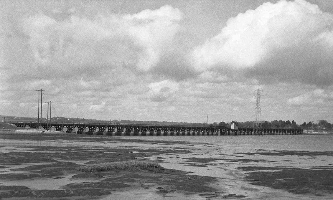 April 1964
Following closure and from across mud flats the 1100ft Langstone timber viaduct allowed the railway to reach Hayling Island from Havant. 
  Martin Tester (CC-by-SA/2.0)
