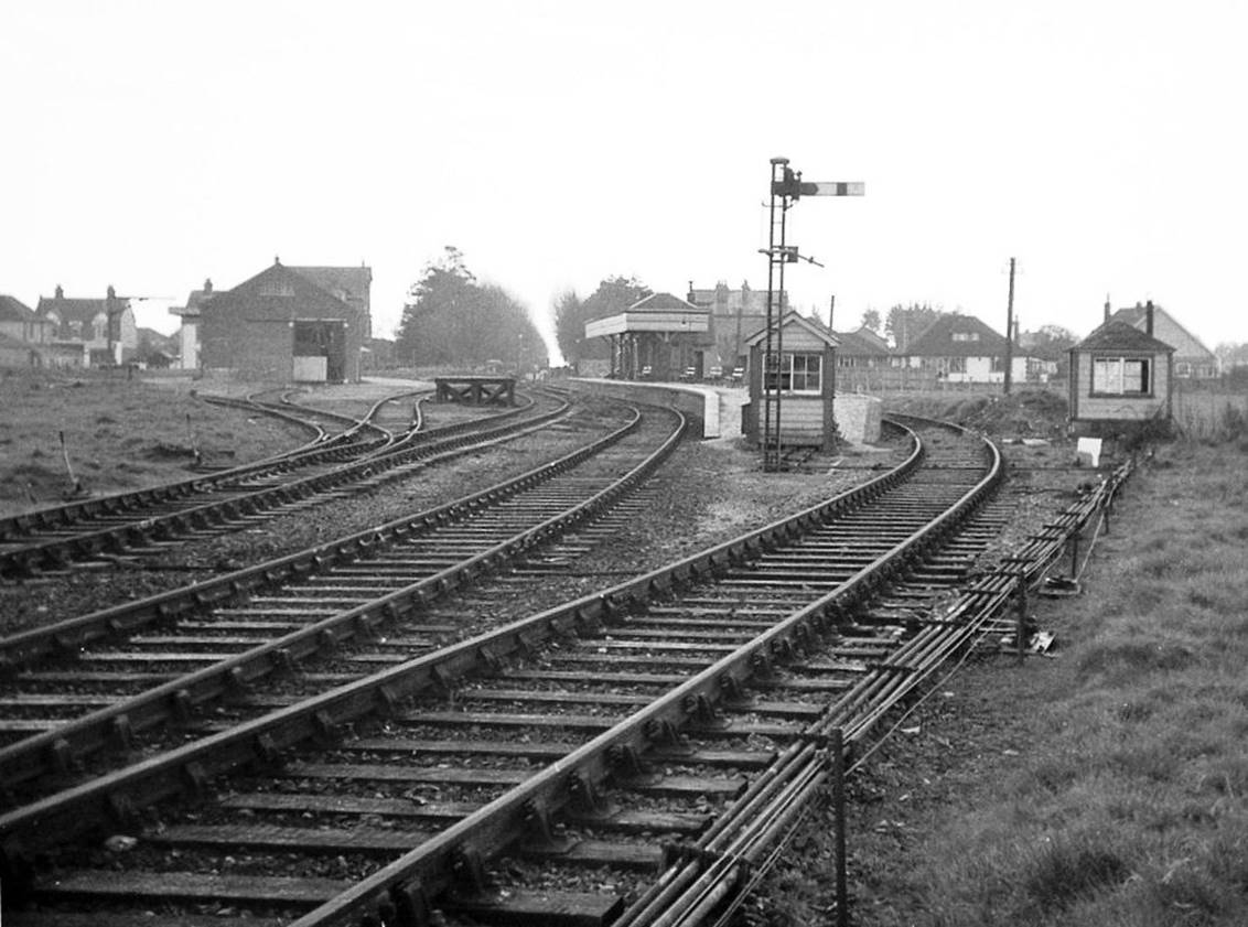 April 1964
Whilst this scene all looks so complete, the lack of rolling stock in the goods yard yields a clue that the Hayling Island branch line has been closed   some five months previously and prior to demolition that year. 
With its diminutive ten-lever frame, the small hut at the end of the platform is the signal box with signal no.9 for No.2 Road (platform) immediately adjacent. Signal 10 (No.1 Road   bay platform) has been removed. As a terminus, its distant was fixed.
  Martin Tester (CC-by-SA/2.0)
