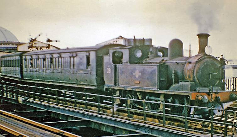 28th August 1965
In the penultimate summer of steam services on the Isle of Wight, W28 leaves Ryde Pier Head with the 14.20 to Shanklin. Adams O2 no. W28 'Ashey' was built July 1890 as no. 186, shipped to the island in March 1926 and withdrawn December 1966.
© Ben Brooksbank (CC-by-SA/2.0)
