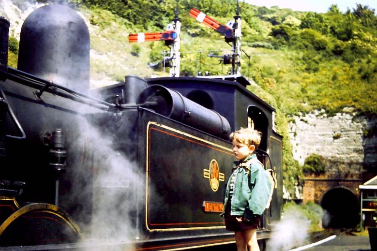 A child standing next to a train

Description automatically generated with medium confidence