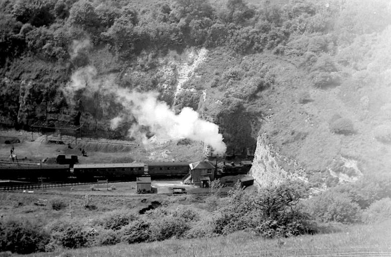 A black and white photo of a building with smoke coming out of it

Description automatically generated with medium confidence